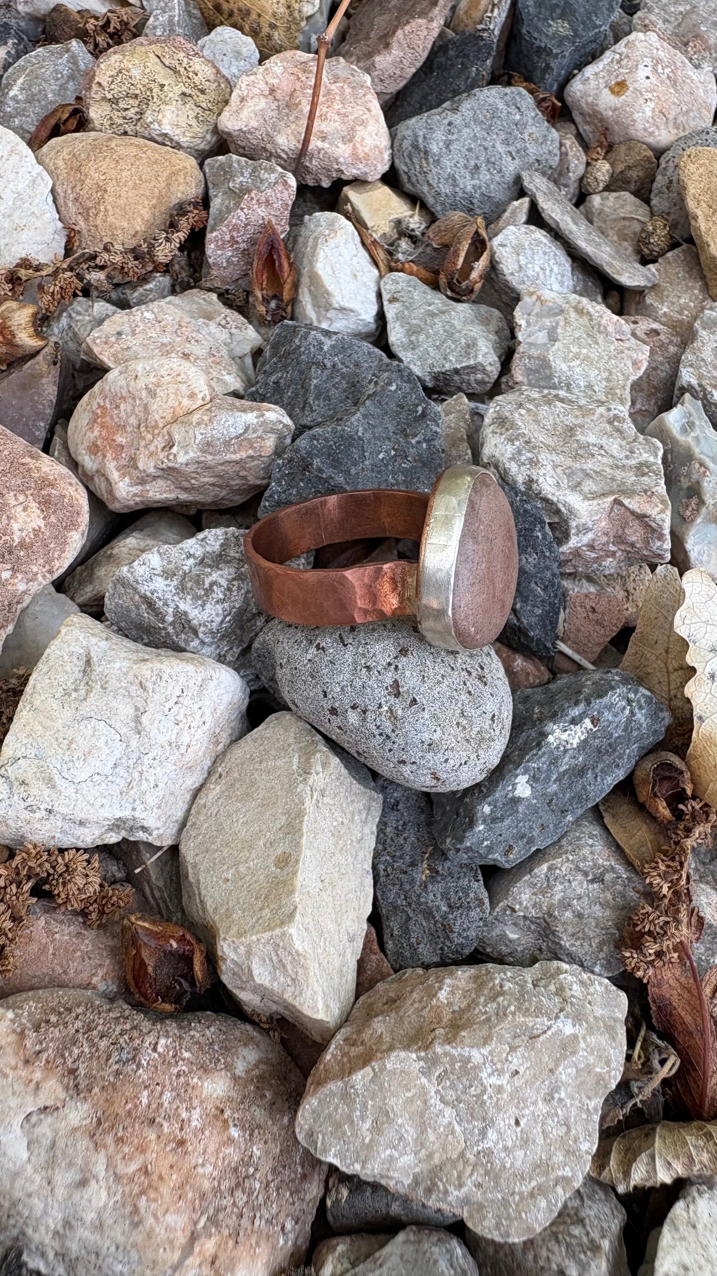 Metallic ring on a pile of multicolored stones